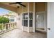 Inviting front porch with ceiling fan, bay window, and decorative glass front door at 6529 Thicket Trl, New Port Richey, FL 34653