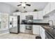 Bright kitchen featuring stainless steel appliances, white cabinetry, and a tile backsplash at 6529 Thicket Trl, New Port Richey, FL 34653