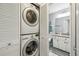 Convenient laundry closet with stacked washer and dryer and bathroom access at 6529 Thicket Trl, New Port Richey, FL 34653