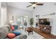 Comfortable living room featuring vaulted ceilings, a ceiling fan and luxury vinyl plank flooring at 6529 Thicket Trl, New Port Richey, FL 34653