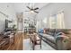 Open-concept living room and dining area with vaulted ceilings, ceiling fan and luxury vinyl plank flooring at 6529 Thicket Trl, New Port Richey, FL 34653