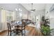 Open-concept living and dining area with stylish furniture, bright windows, and sliding door to patio at 6529 Thicket Trl, New Port Richey, FL 34653
