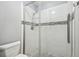 Updated shower with white subway tile, a decorative accent stripe, and glass doors for a modern look at 6529 Thicket Trl, New Port Richey, FL 34653
