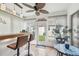 Enclosed lanai/sunroom featuring tile flooring, a bar and a ceiling fan at 6529 Thicket Trl, New Port Richey, FL 34653
