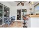 Enclosed lanai/sunroom featuring tile flooring, a ceiling fan, and a view to the living room at 6529 Thicket Trl, New Port Richey, FL 34653
