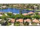 Scenic aerial view of waterfront homes on lake with fountains and lush landscaping, in quiet neighborhood at 772 Live Oak Ne Ter, St Petersburg, FL 33703