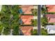 Aerial view of well-maintained neighborhood with lush landscaping, terracotta tile roofs, and paved streets at 772 Live Oak Ne Ter, St Petersburg, FL 33703