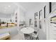 Eat-in kitchen area with white table, chairs, and multiple windows, plus view to the kitchen at 772 Live Oak Ne Ter, St Petersburg, FL 33703