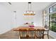 Bright dining room featuring a large window, wood floors, a long wooden table, and a stylish buffet at 772 Live Oak Ne Ter, St Petersburg, FL 33703