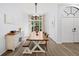 Bright dining room featuring a large window, wood floors, a long wooden table, and a stylish buffet at 772 Live Oak Ne Ter, St Petersburg, FL 33703