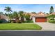 Lush landscaping and palm trees accentuate this beautiful home with a terracotta colored roof at 772 Live Oak Ne Ter, St Petersburg, FL 33703