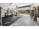 Spacious garage transformed into a home gym and workshop with open doors to the driveway at 772 Live Oak Ne Ter, St Petersburg, FL 33703