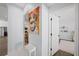 Hallway featuring colorful art and doorways leading to other rooms, offering a glimpse into the home's layout and design at 772 Live Oak Ne Ter, St Petersburg, FL 33703