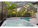 Relaxing hot tub and screened pool area with tropical landscaping offers a private retreat at 772 Live Oak Ne Ter, St Petersburg, FL 33703