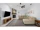Cozy living room featuring a fireplace, neutral paint, ceiling fan and plush sofa at 772 Live Oak Ne Ter, St Petersburg, FL 33703