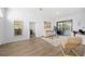 Inviting living room with sliding glass doors to outdoor living space and views, stylish seating, and neutral decor at 772 Live Oak Ne Ter, St Petersburg, FL 33703