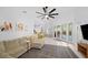Bright living room with large sofa and view to the pool and backyard at 772 Live Oak Ne Ter, St Petersburg, FL 33703