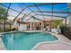 Screened pool with covered patio and lush landscaping provides an oasis for outdoor living at 772 Live Oak Ne Ter, St Petersburg, FL 33703