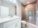 Modern bathroom with glass shower, mosaic tile, and white vanity at 7733 93Rd N St # 26, Seminole, FL 33777