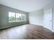 Minimalist bedroom featuring hardwood floors, a large window, and neutral paint at 7733 93Rd N St # 26, Seminole, FL 33777