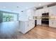 Bright kitchen featuring stainless steel appliances, white cabinets, and center island with sink at 7733 93Rd N St # 26, Seminole, FL 33777