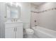 Bright bathroom features a sleek vanity, toilet, and tub with tiled walls and decorative accents at 805 E Elm St, Tampa, FL 33604