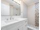 Modern bathroom featuring a vanity with a white countertop, stylish fixtures, and tiled shower at 805 E Elm St, Tampa, FL 33604