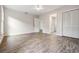 Spacious bedroom featuring wood-look flooring, closet, and ensuite bathroom access at 805 E Elm St, Tampa, FL 33604