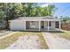 Charming single-story home featuring a welcoming porch and neutral exterior paint at 805 E Elm St, Tampa, FL 33604