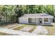 Cozy home with covered porch and double driveway, nestled amongst lush trees offering charm and shade at 805 E Elm St, Tampa, FL 33604