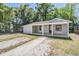 Charming single-story home with a covered porch, offering a welcoming facade and curb appeal at 805 E Elm St, Tampa, FL 33604