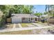 Well-kept home with covered porch, featuring a neat lawn and convenient double driveway at 805 E Elm St, Tampa, FL 33604