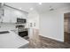 Modern kitchen with stainless steel oven, white cabinets, and an adjacent living space at 805 E Elm St, Tampa, FL 33604