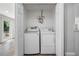 A modern stacked laundry closet with updated appliances at 805 E Elm St, Tampa, FL 33604