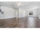 Open-concept living room featuring wood-look flooring, great lighting, and access to other rooms at 805 E Elm St, Tampa, FL 33604