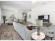 Staged living room featuring wood-look tile flooring, modern furniture, and open-concept design at 805 E Elm St, Tampa, FL 33604