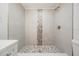Beautifully renovated shower featuring decorative mosaic tile accents and modern fixtures at 805 E Elm St, Tampa, FL 33604