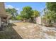 Expansive backyard featuring a storage shed and mature trees at 831 72Nd N Ave, St Petersburg, FL 33702