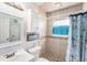 Charming bathroom with nautical decor, vanity, and tiled shower at 831 72Nd N Ave, St Petersburg, FL 33702