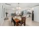 Dining room with tile flooring, a modern chandelier, and views into the living room and kitchen at 831 72Nd N Ave, St Petersburg, FL 33702