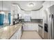 Modern kitchen features white cabinetry, granite countertops, stainless steel appliances, and tile backsplash at 831 72Nd N Ave, St Petersburg, FL 33702