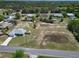 Aerial view of homes in the neighborhood with a large, clear lot at 8442 Pinewood Ave, Brooksville, FL 34613
