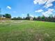 Spacious backyard with a large grassy area and a fence at 8442 Pinewood Ave, Brooksville, FL 34613