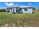 View of the backyard featuring the rear of the light-blue home at 8442 Pinewood Ave, Brooksville, FL 34613