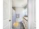 Bright bathroom featuring white cabinets, tile flooring, and a granite countertop at 8442 Pinewood Ave, Brooksville, FL 34613