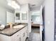 This bathroom has granite countertops, wood cabinets, and tile floors at 8442 Pinewood Ave, Brooksville, FL 34613