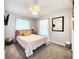 Comfortable bedroom features a queen bed with soft pillows and window with sheer curtains for natural light at 8442 Pinewood Ave, Brooksville, FL 34613