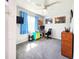 Bedroom with work space featuring a desk, printer, and wall-mounted television at 8442 Pinewood Ave, Brooksville, FL 34613