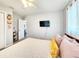 Comfortable bedroom features a queen bed with soft pillows and window with sheer curtains for natural light at 8442 Pinewood Ave, Brooksville, FL 34613
