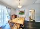 Dining room features hardwood floors and natural light from the sliding glass door at 8442 Pinewood Ave, Brooksville, FL 34613